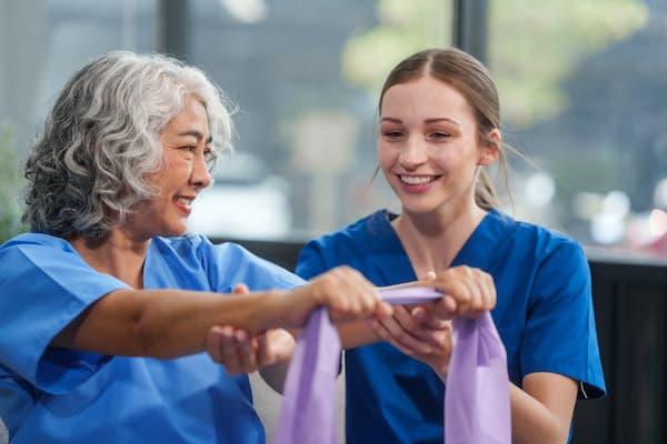 An aged care female nurse showing stretching exercises to a patient