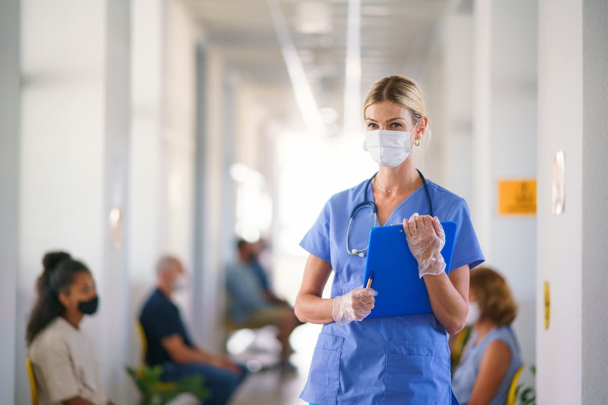 A young female nurse wearing a face mask in a hospital