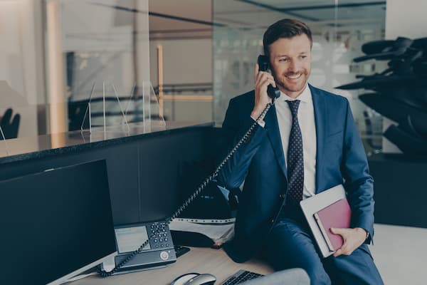 A sales manager on the phone smiling
