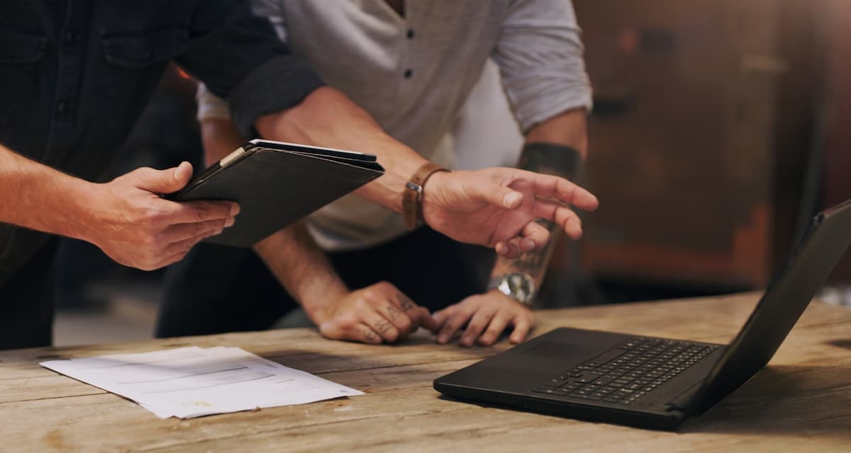 Details of two people reviewing data on a laptop