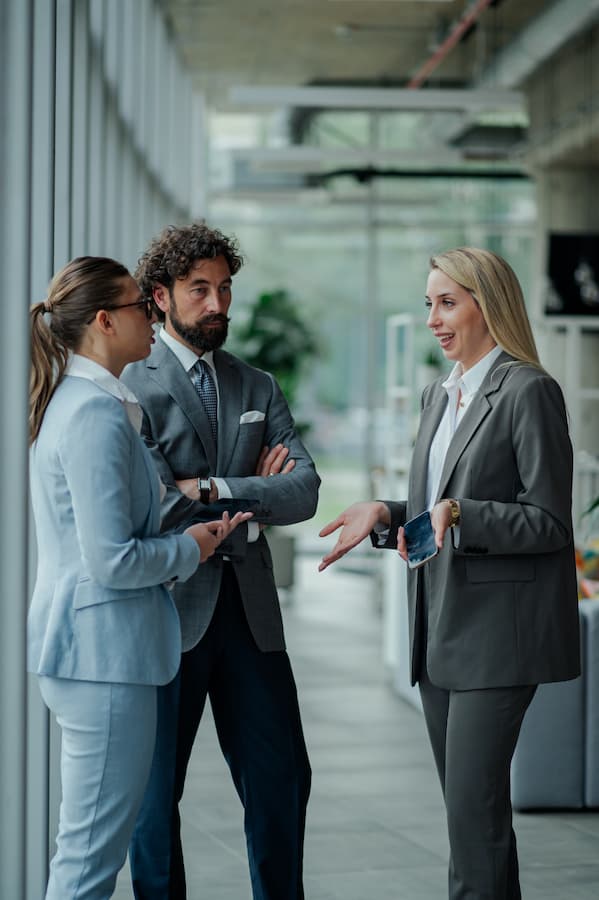 Business woman discussing with colleagues in modern building