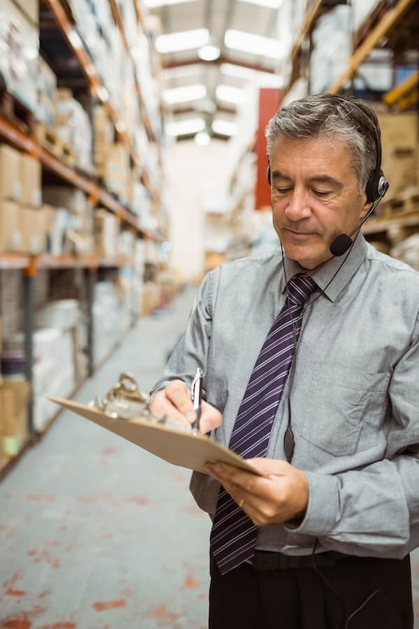 Logistics warehouse manager handling inventory