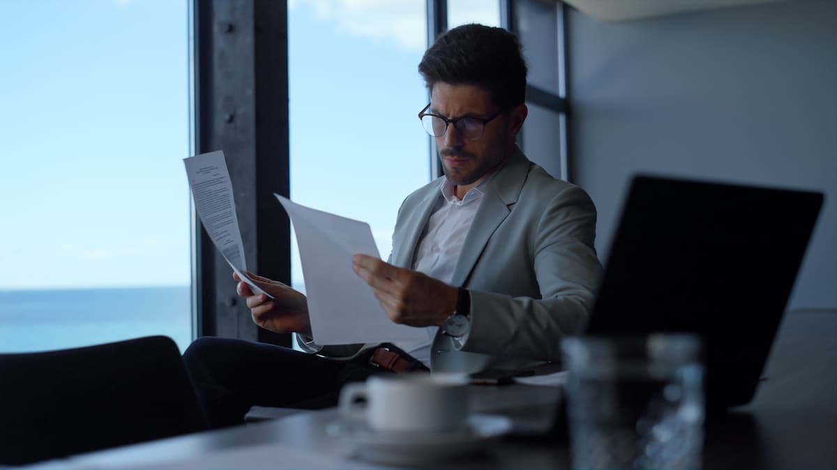 A businessman reviewing documents at his desk