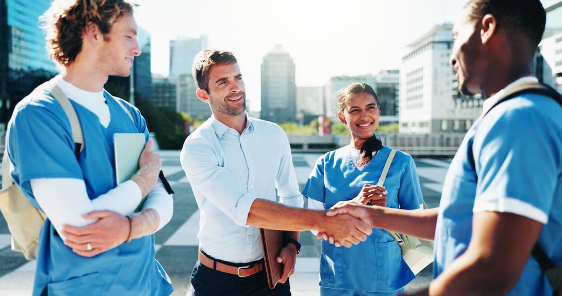 healthcare manager with nurses outdoors