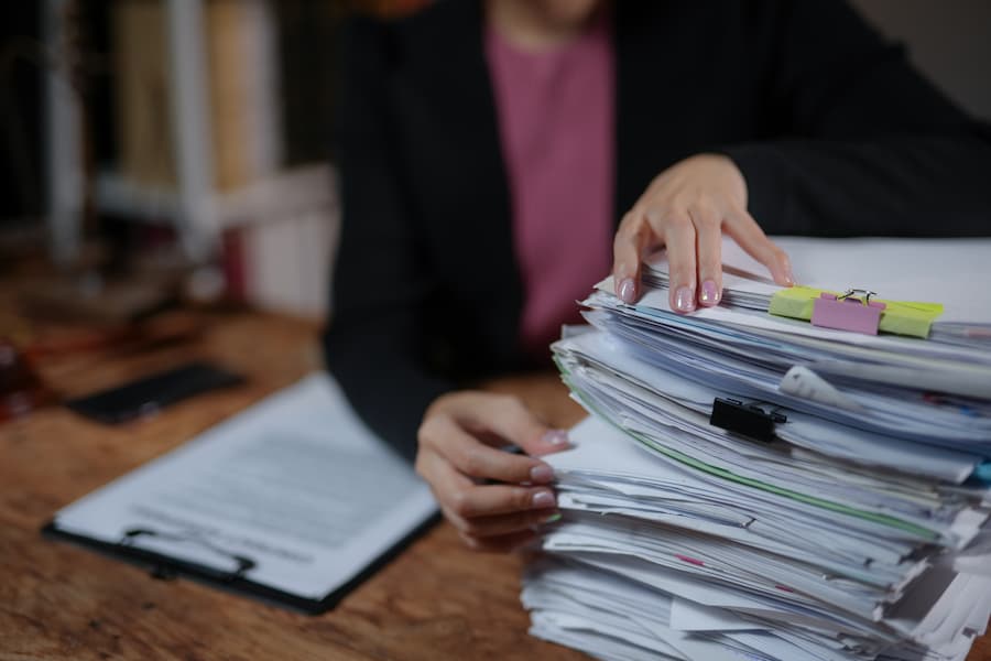 Recruiter's desk with stack of resumes