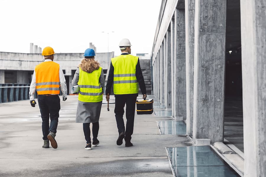 Construction Crew Walking Through An Urban Construction Site
