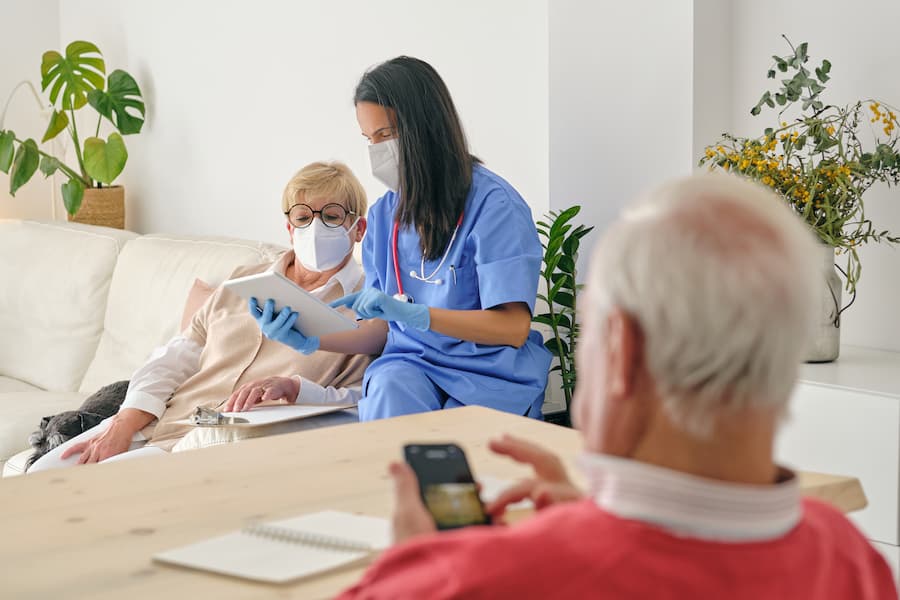Doctor visiting elderly patient at home