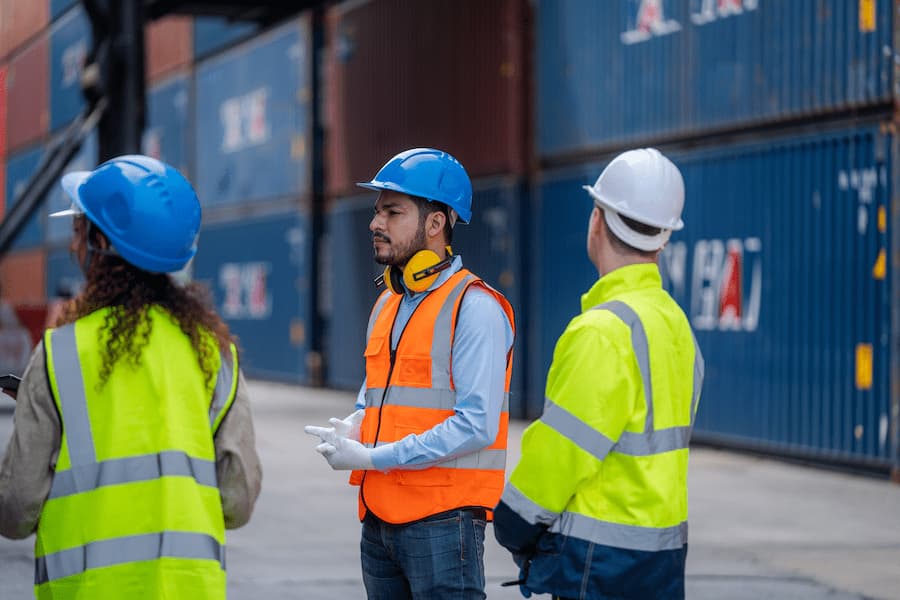 Warehouse Workers Reviewing Shipping Containers