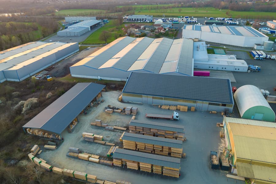 Aerial view of goods warehouses and logistics center in industrial city zone from above