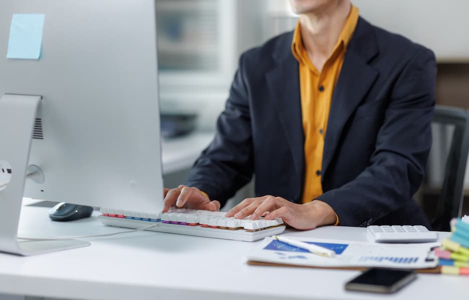 Business professional typing on computer working in office