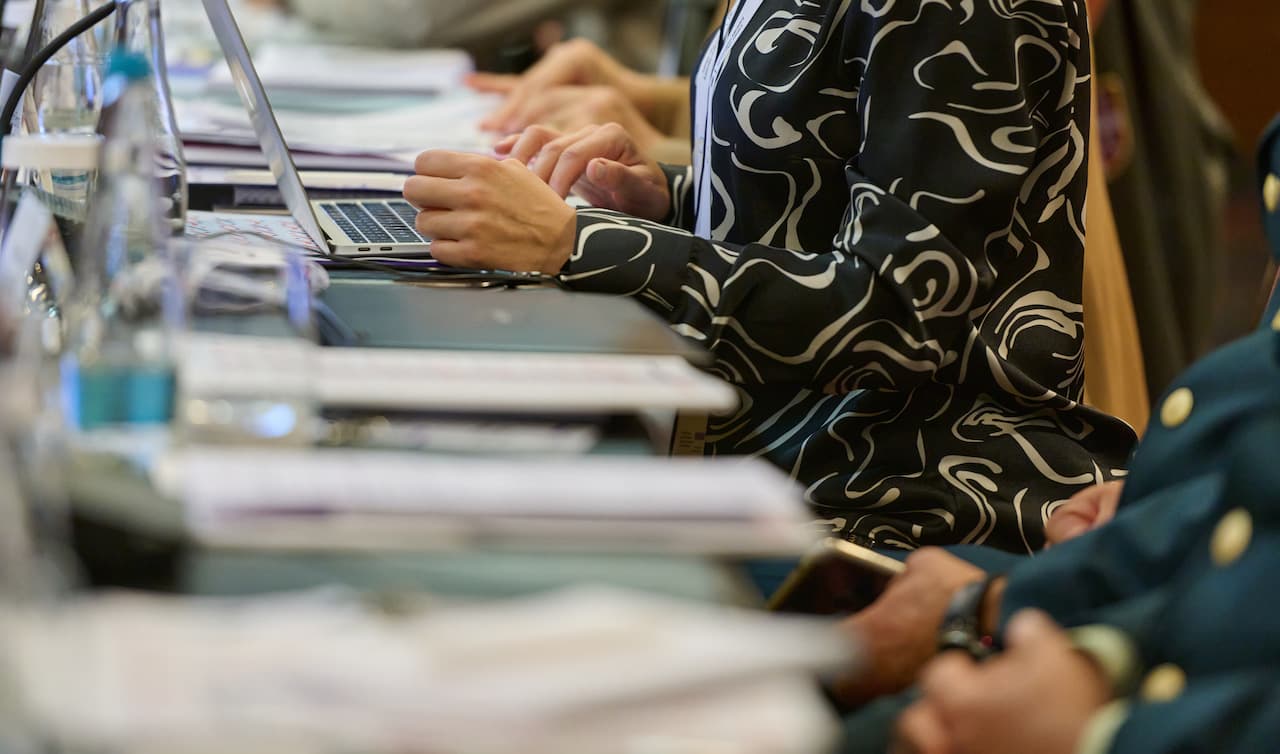 View of admin professionals working together at busy office