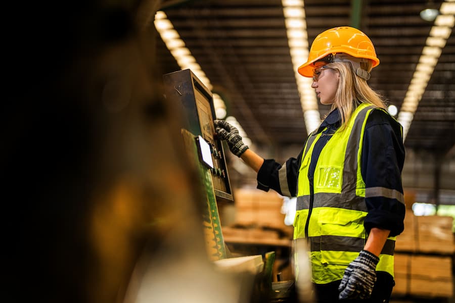 Warehouse worker packing item during night shift