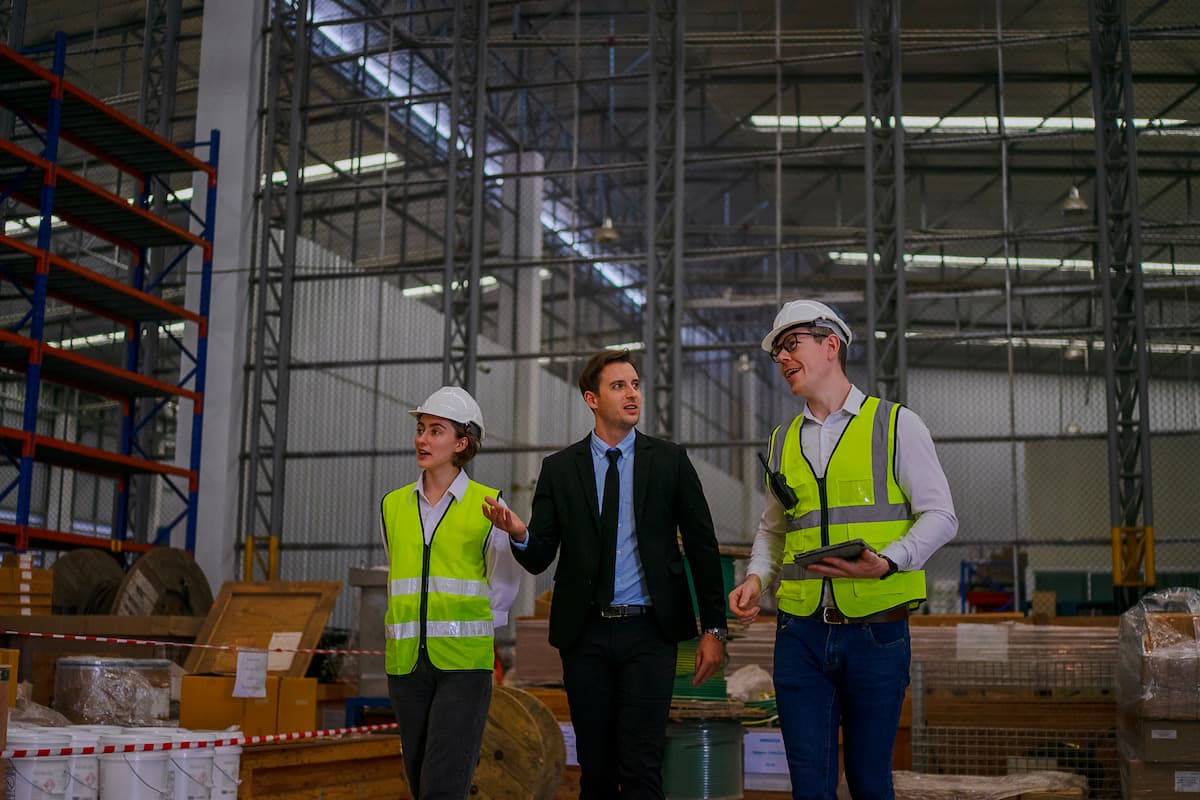 Warehouse workers discussing with the logistics manager