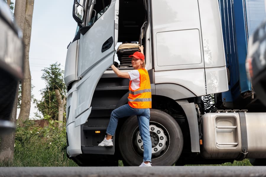 Woman Climbs into Cab of Modern Semi Truck
