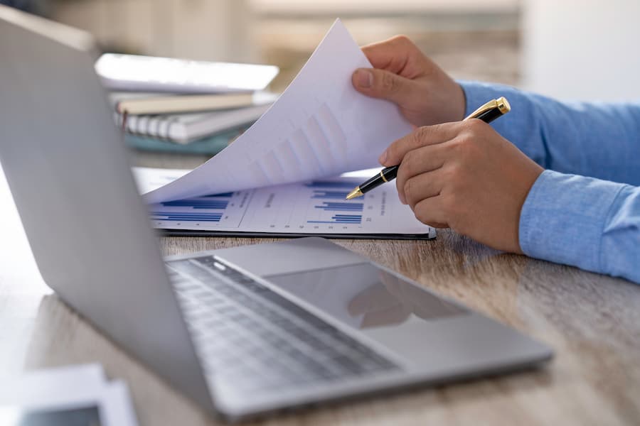 Accounts Receivable Officer reviewing charts on desk