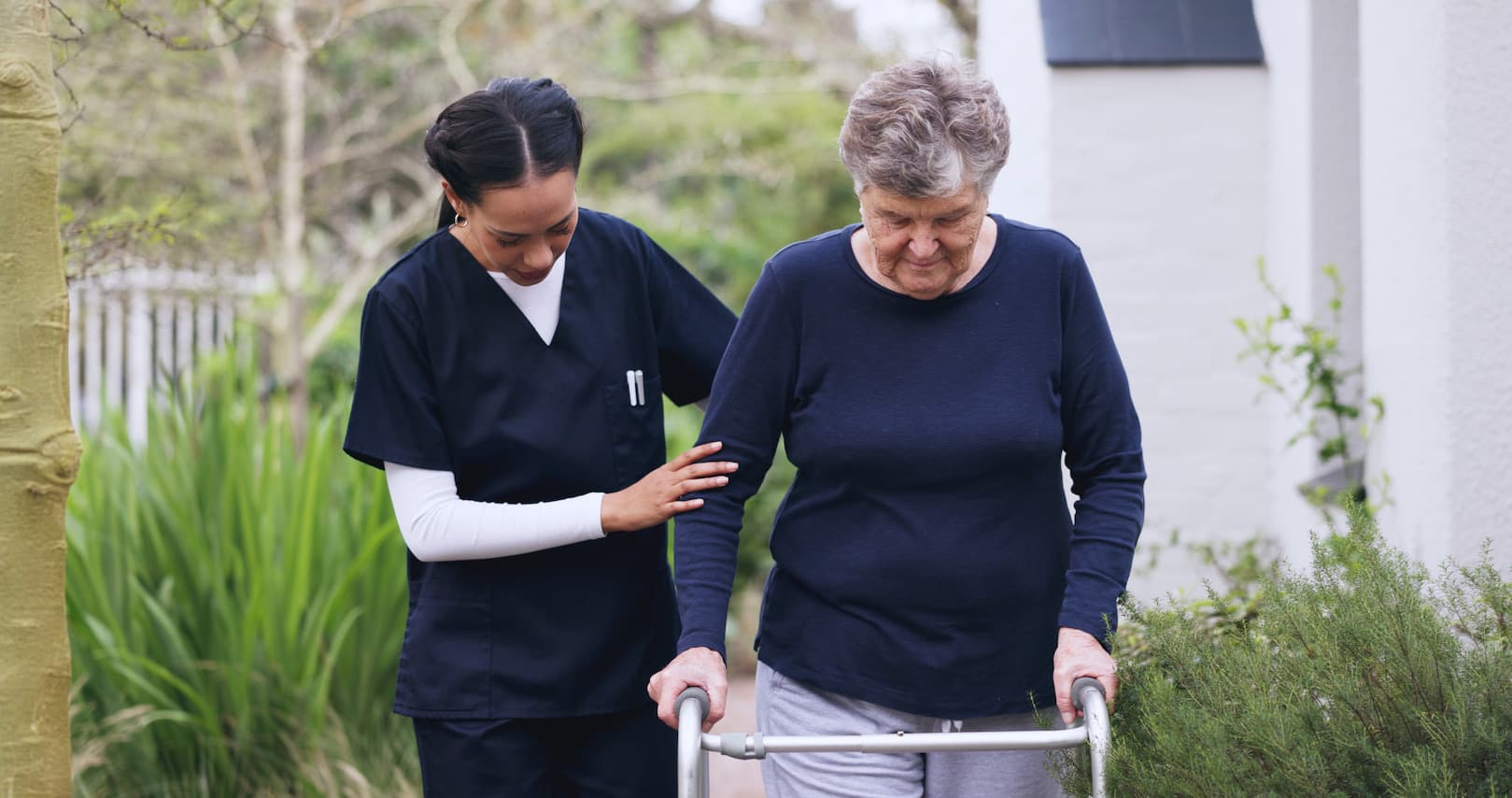 assistant in nursing helping elderly resident, aged care facility