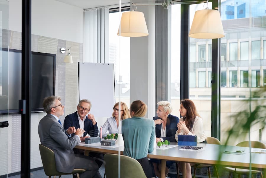 Business Meeting in Modern Office with Scale Model