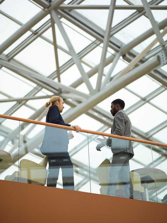 Business Professionals Meeting in Modern Atrium