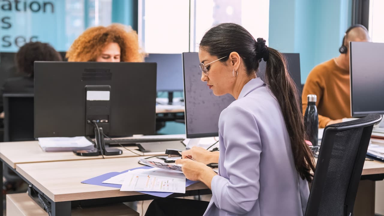 Business Professionals Working at Computers in Modern Office