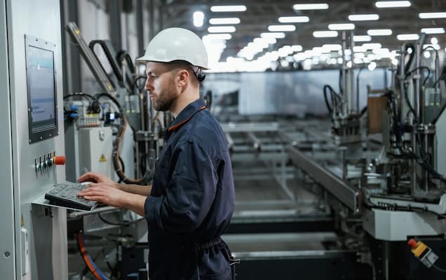 Factory worker operating machinery