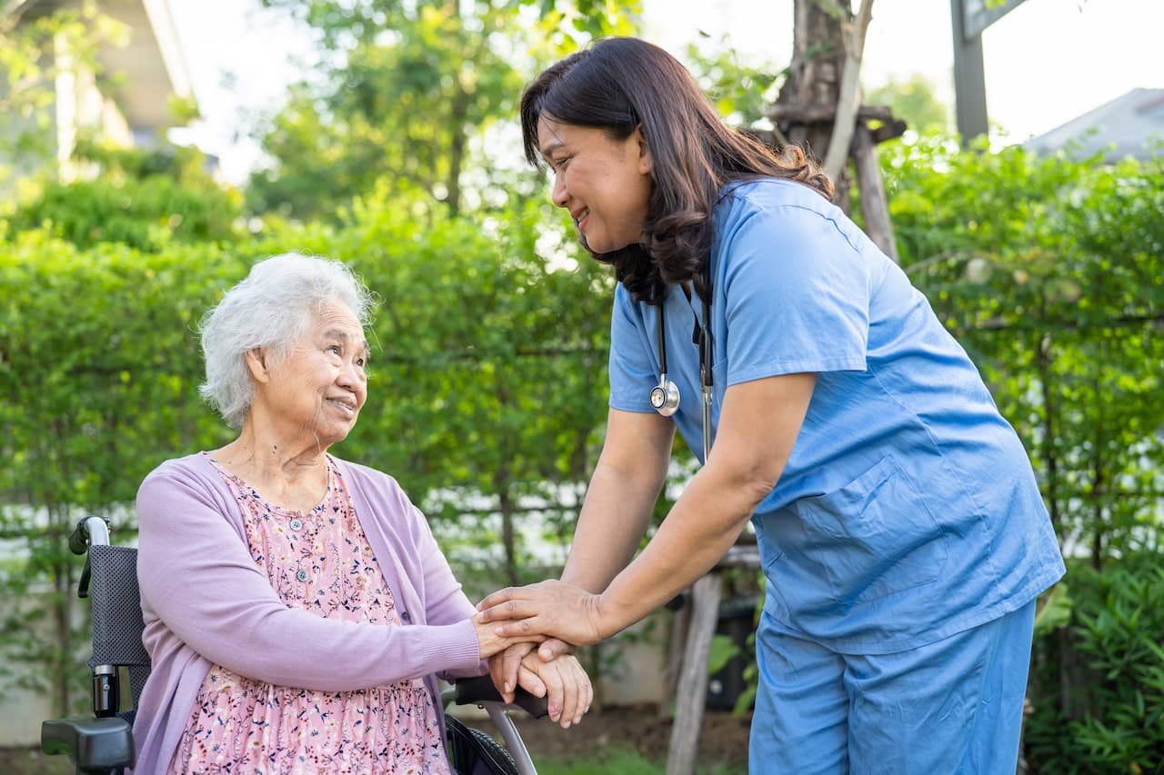 Caregiver help and care Asian elderly woman patient