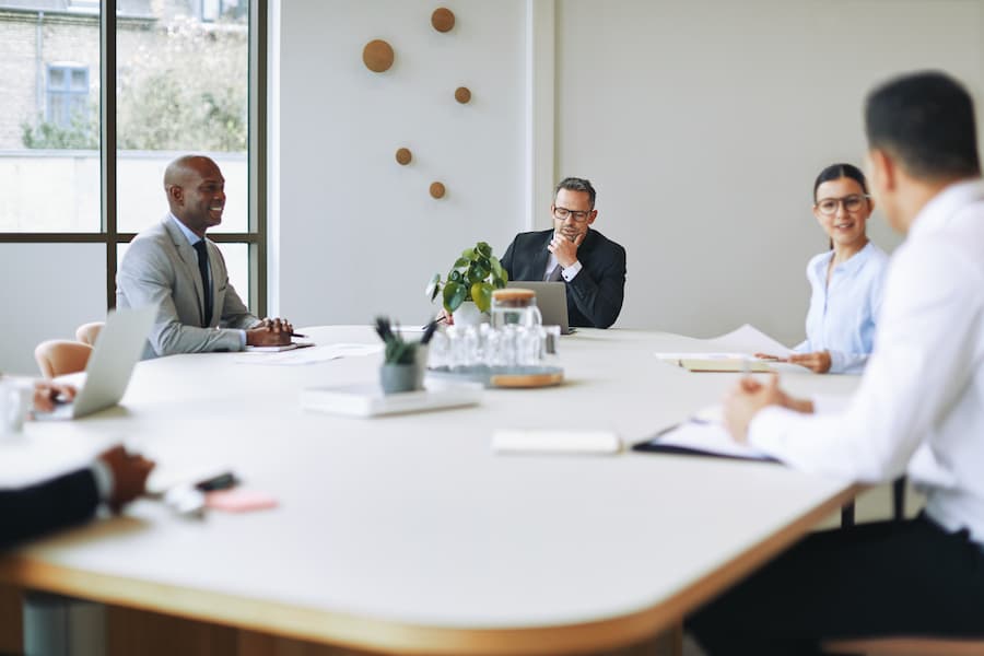 Corporate Meeting around a Large Table Indoors