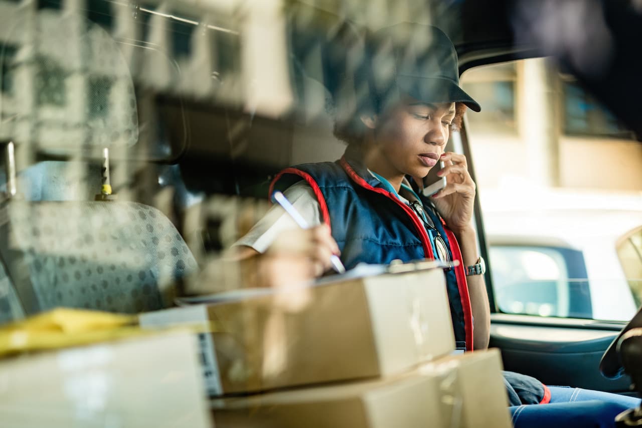 Courier Coordinating Deliveries from Inside a Delivery Van