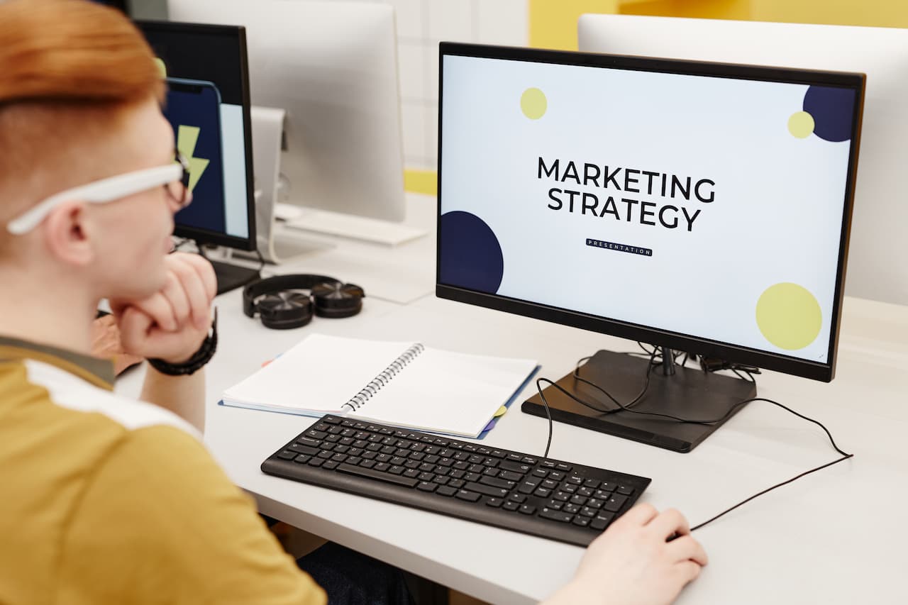 Digital Marketing Specialist preparing Marketing Strategy on Computer