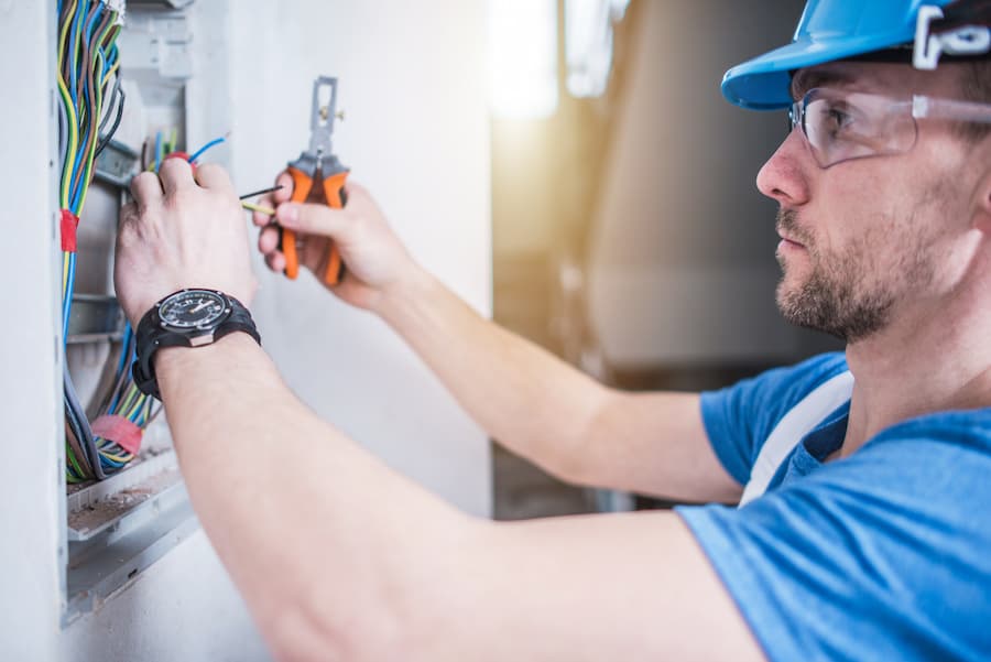 Electrician working on electrical box wiring