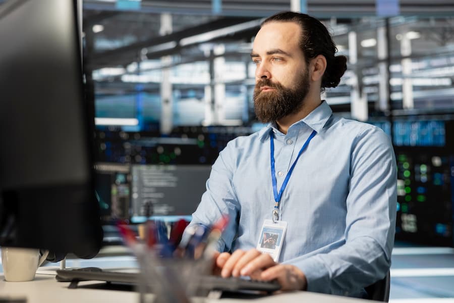 Employee working in server hub, managing large datasets for AI training