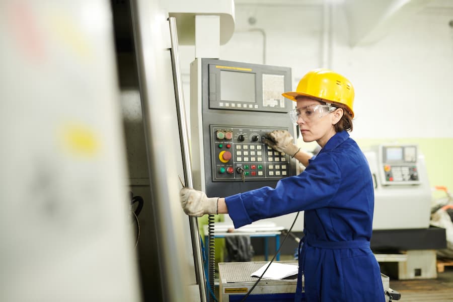 Female Foreman at Factory operating CNC machinery
