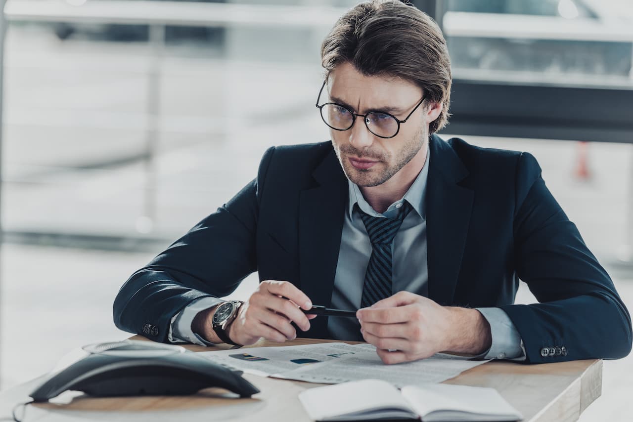 Focused male Sales Representative Works at a Desk