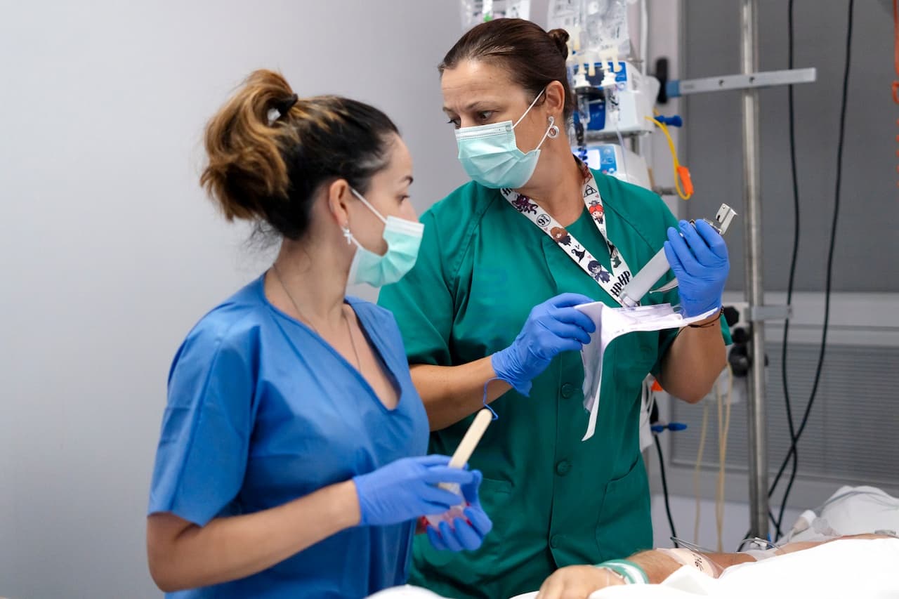 Healthcare professionals collaborating on patient treatment in hospital unit