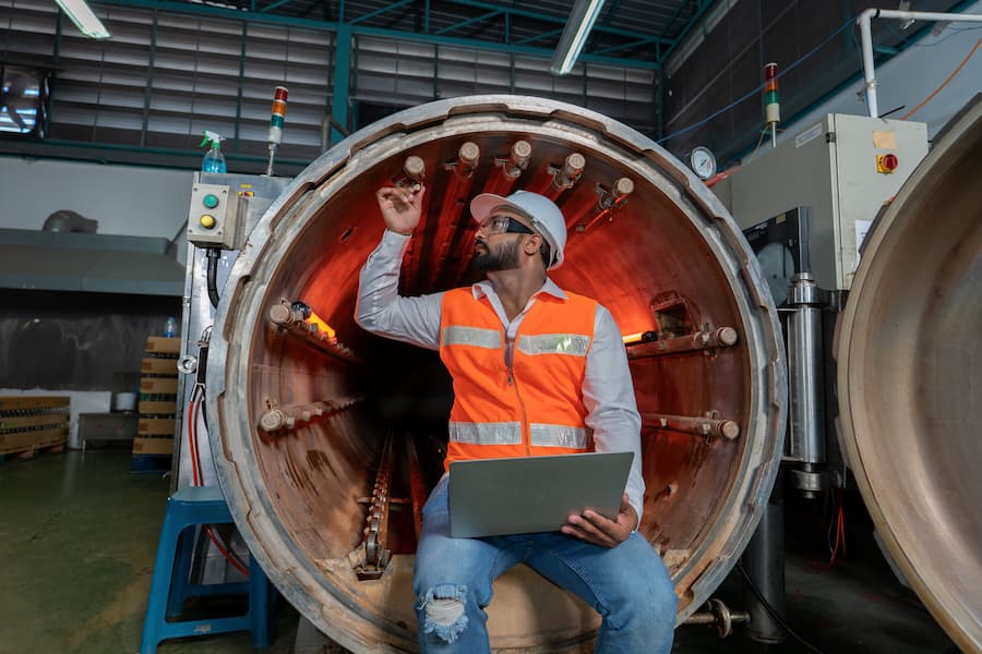 Industrial Worker Inspecting a Boiler in a Factory