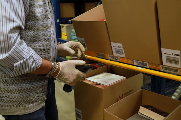 logistics warehouse - operator with a scanner in his hand