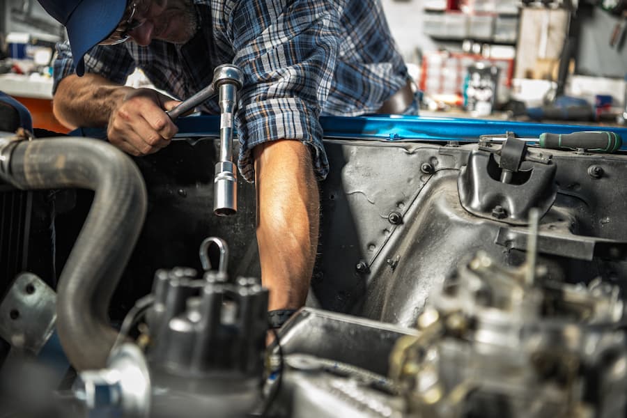 Man Repairing Car Engine in Auto Repair Shop