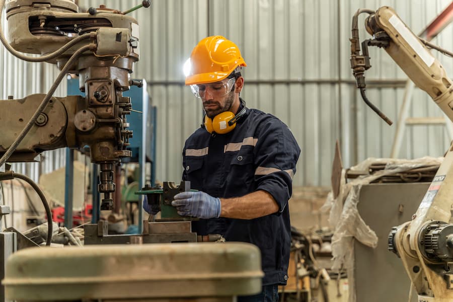 Man Working on Industrial Equipment in Factory