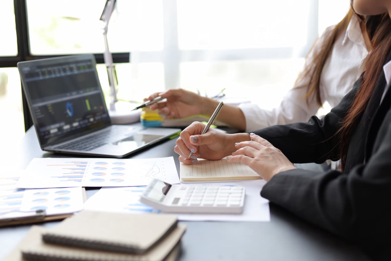 Management accountant and stakeholder evaluate charts and financial documents