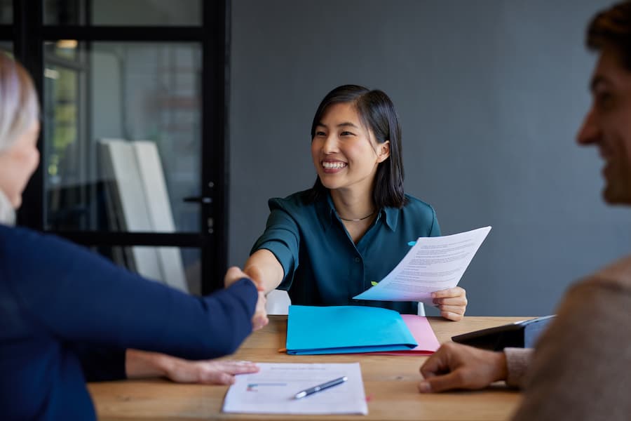 Positive Businesswoman Handshake Meeting In Office