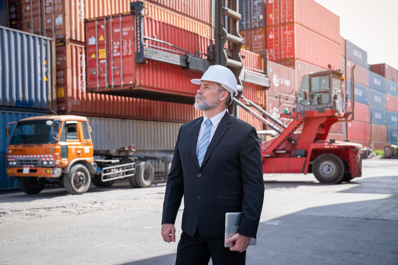 Professional Man With Tablet At Shipping Port