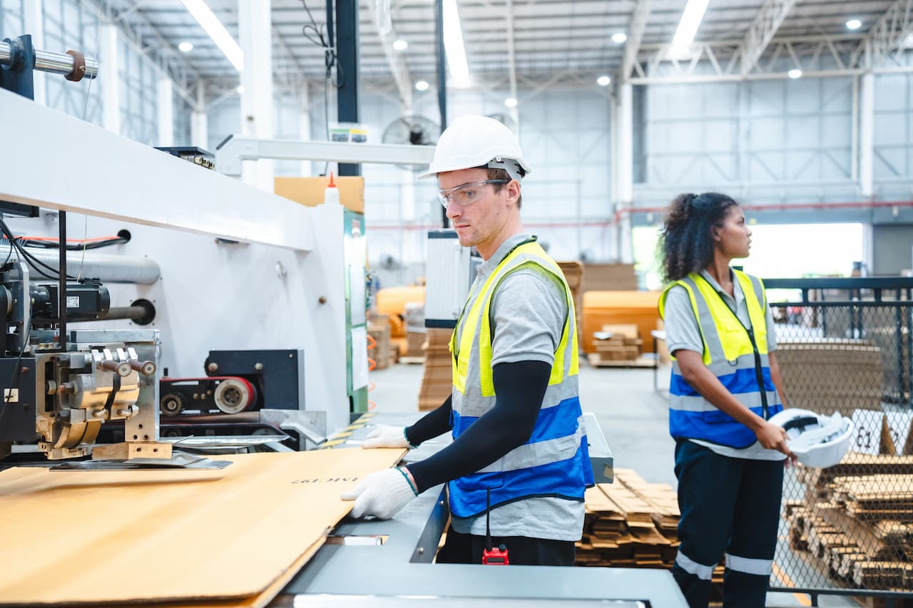 Professional worker supervisor inspector packaging stock order at factory warehouse