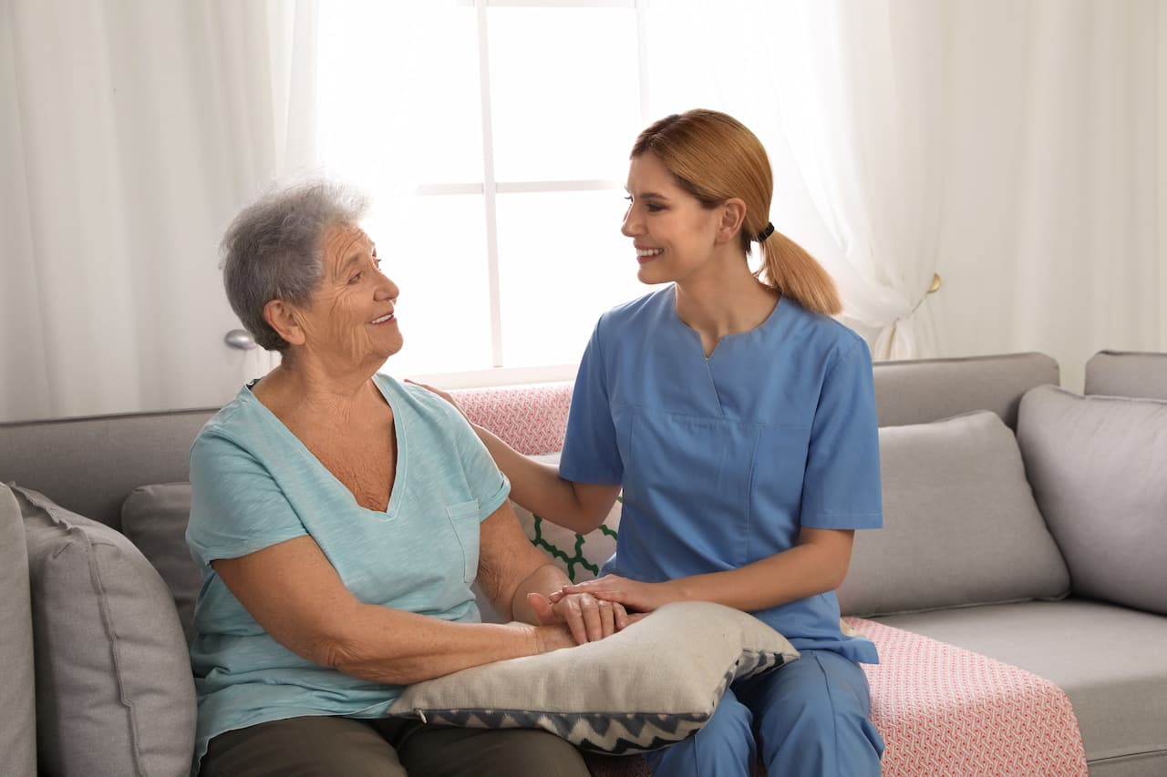 Smiling Senior Woman with Caregiver at Home