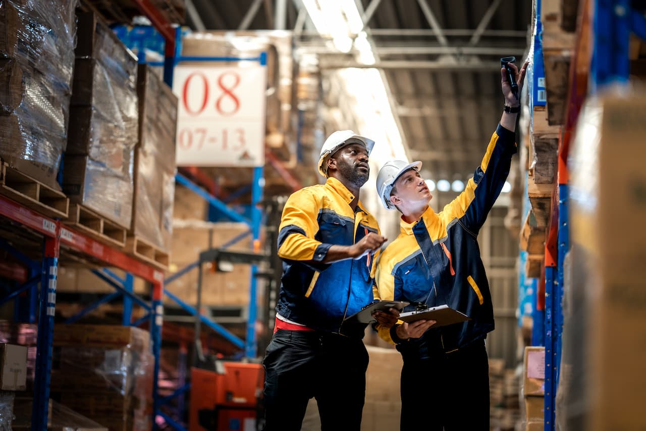 Two distribution coordinators in logistics warehouse