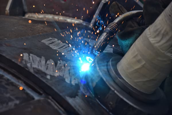 Welder Sparks Fly During Steel Fabrication Process