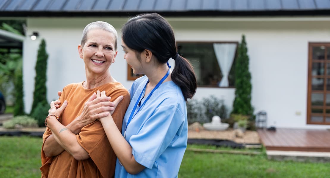 Woman with Short Hair Smiles with Nurse Outside