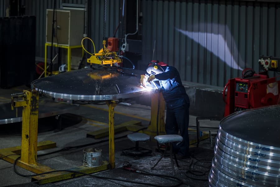 A welder welding in a factory