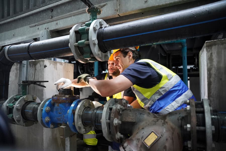Workers Inspecting Valves in an Industrial Setting