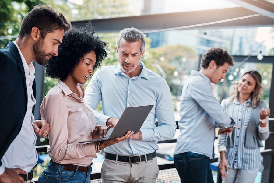 Business Professionals Reviewing Data On a Laptop at event