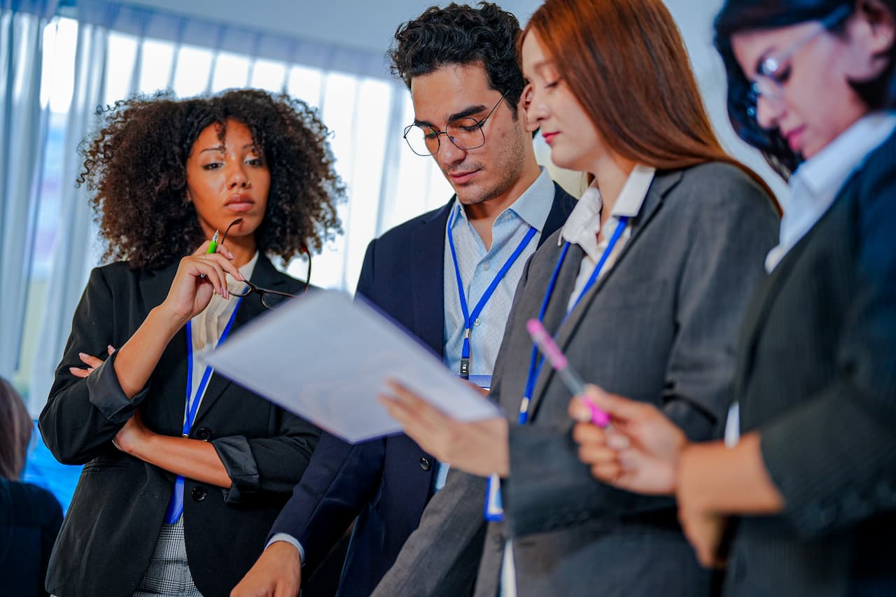 Professional Team Collaborating On Documents In A Modern Office Setting