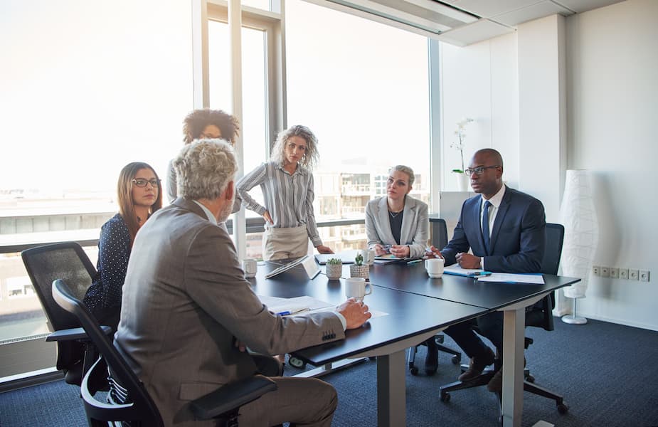 Executives talking business together in an office boardroom